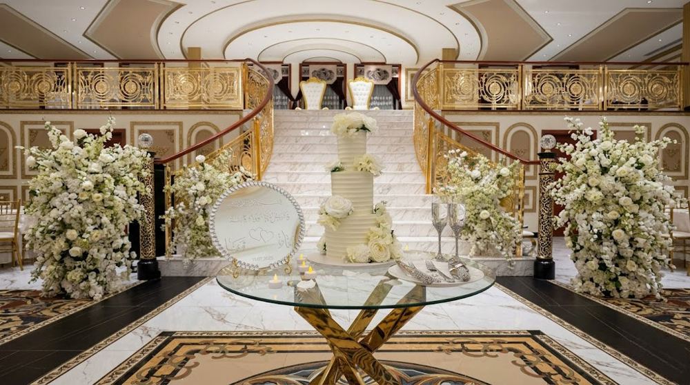 Three-tier wedding cake in a ballroom